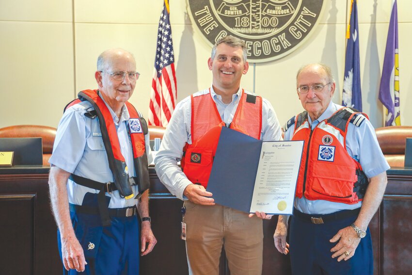 Sumter Mayor David P. Merchant, center, holds a proclamation recognizing May 18-24 as National Safe Boating Week.