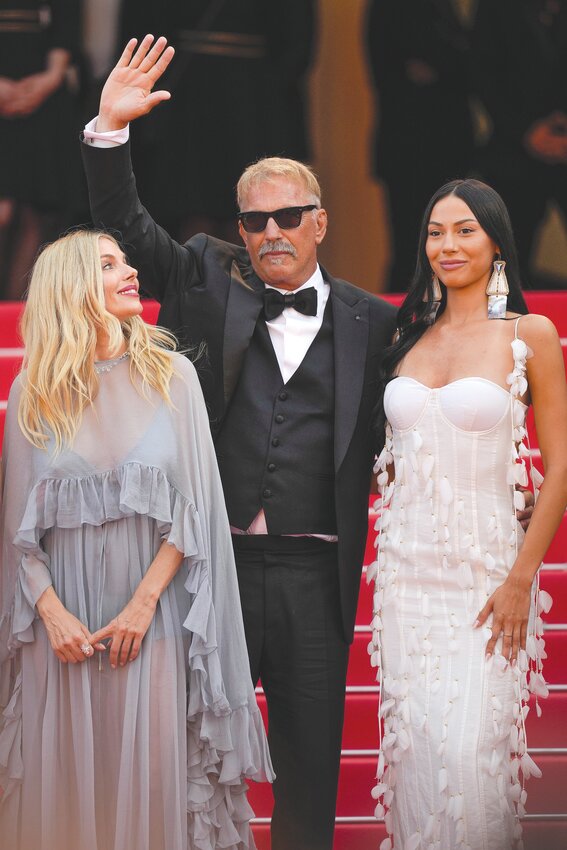 From left, Sienna Miller, Kevin Costner and Wase Chief pose for photographers upon arrival at the premiere of the film &quot;Horizon: An American Saga&quot; at the 77th international film festival, Cannes, southern France, on Sunday, May 19.