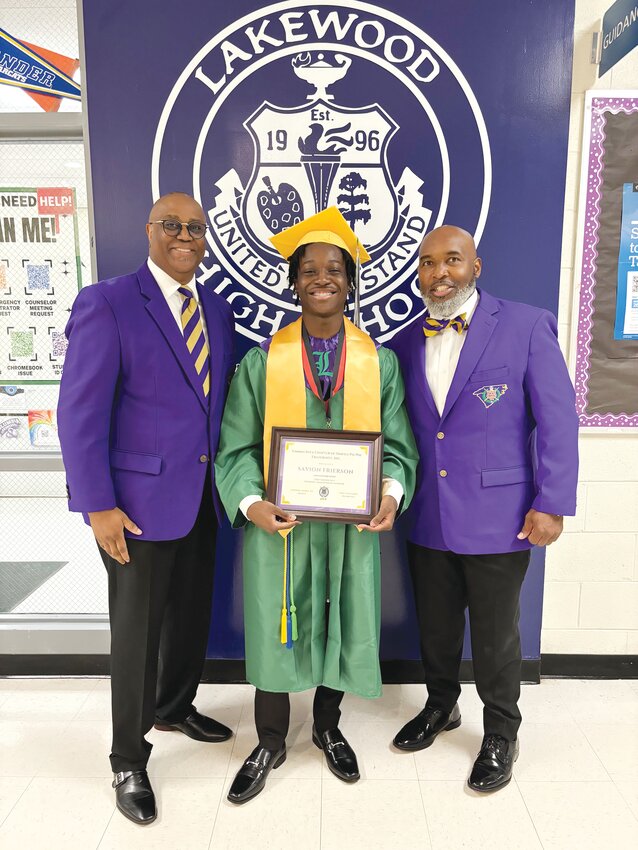 Lakewood High School graduating senior Savion Frierson receives his award recently from Gamma Iota Chapter of Omega Psi Phi brothers Chedric Jones, left, and Arkie McCleary, right.