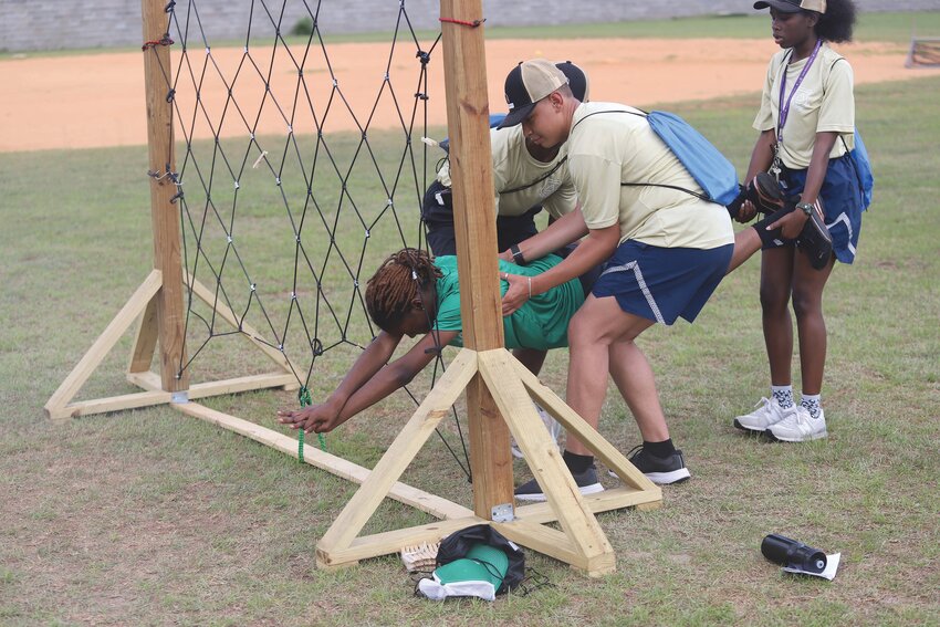 Air Force Junior ROTC cadets work through a team-building exercise, known as the Spider Web, on Wednesday, June 5, at Morris College's inaugural Cadet Leadership Course. Seven high school Air Force Junior ROTC programs participated in the course.