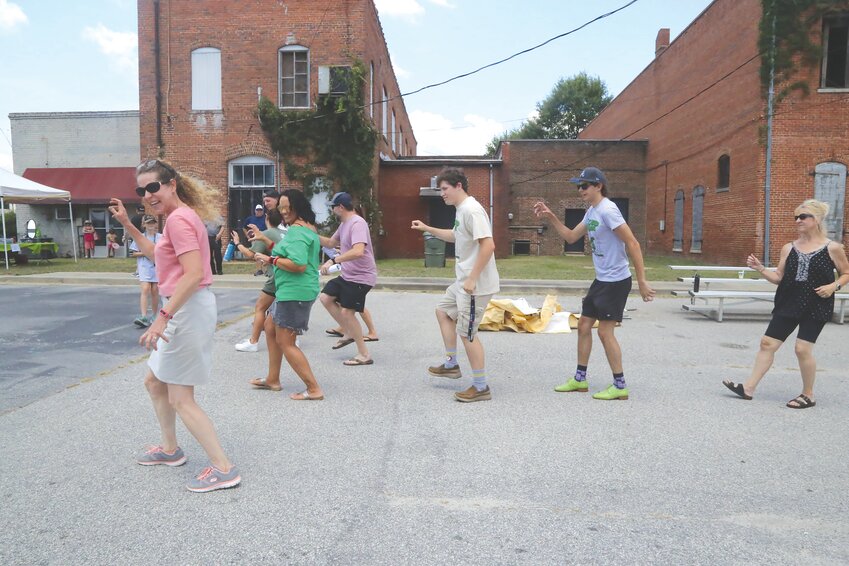 Line dancers perform The Lizard Man Stomp dance in 2022 at the inaugural Lizard Man Stomp in downtown Bishopville. About 500 to 700 people attended the festival, organizers said.