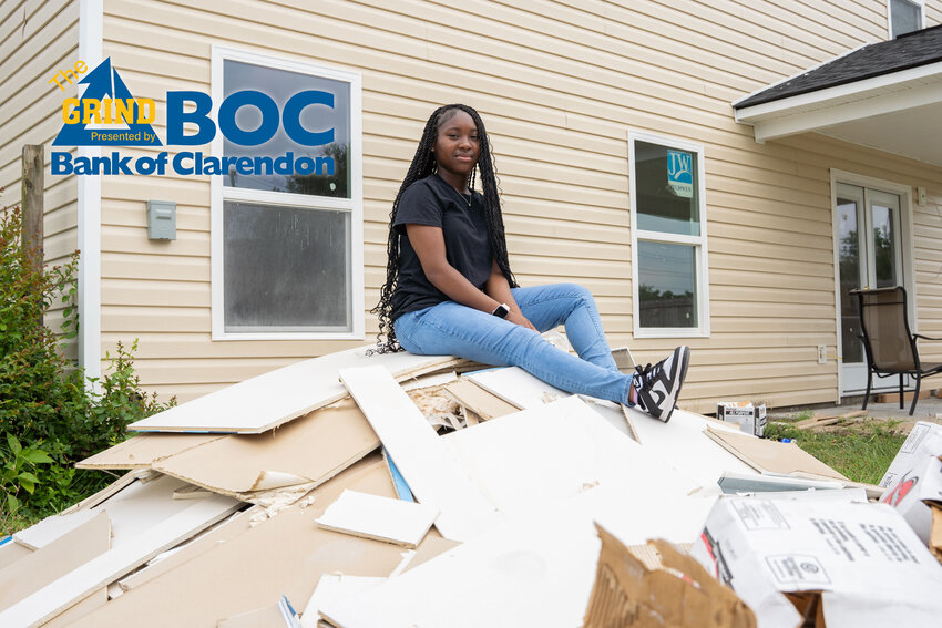 Crestwood's Summer Golston sits on a pile of debris at the construction site for her rebuilt home. Golston's house burned down on Dec. 12, but she still fought through to return to school and her cheer squad at CHS.
