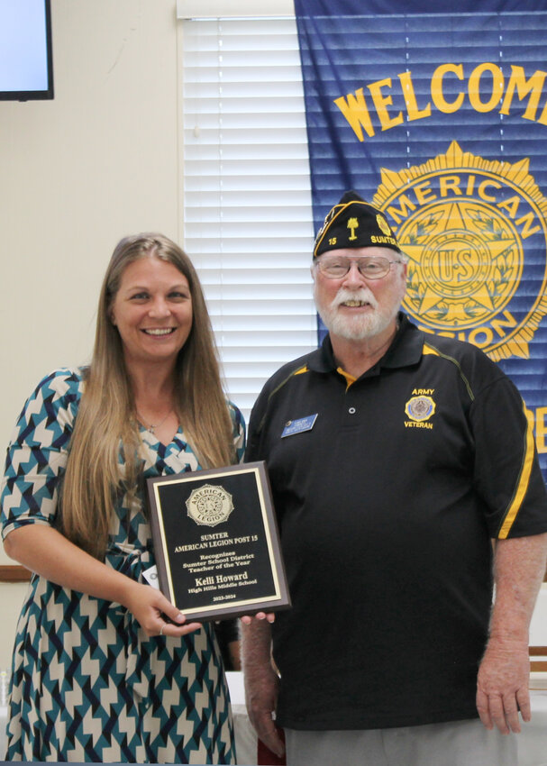 PHOTO PROVIDED  Current Sumter School District Teacher of the Year Kelli Howard, left, is honored by American Legion Post 15 Commander Ken Mixon as the local teacher of the year in a ceremony Monday at American Legion Post 15 headquarters, 34 S. Artillery Drive. The district will name its teacher of the year for the upcoming school year on July 30 at its Back to School Rally.