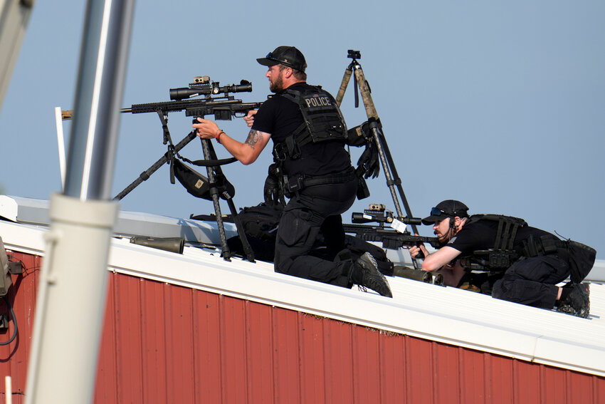 Police snipers return fire after shots were fired while Republican presidential candidate former President Donald Trump was speaking at a campaign event in Butler, Pennsylvania, on Saturday, July 13, 2024.