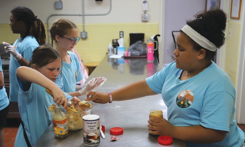 Cadettes, Scouts in the sixth grade and up, learn how to cook simple granola bars during the Fannie Ivey day camp.