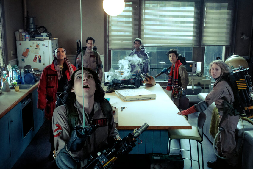 This image released by Columbia Pictures shows Finn Wolfhard, foreground, with Celeste O'Connor, background from left, Paul Rudd, Kamail Nanjiani, Logan Kim and Carrie Coon in a scene from &quot;Ghostbusters: Frozen Empire.&quot;
