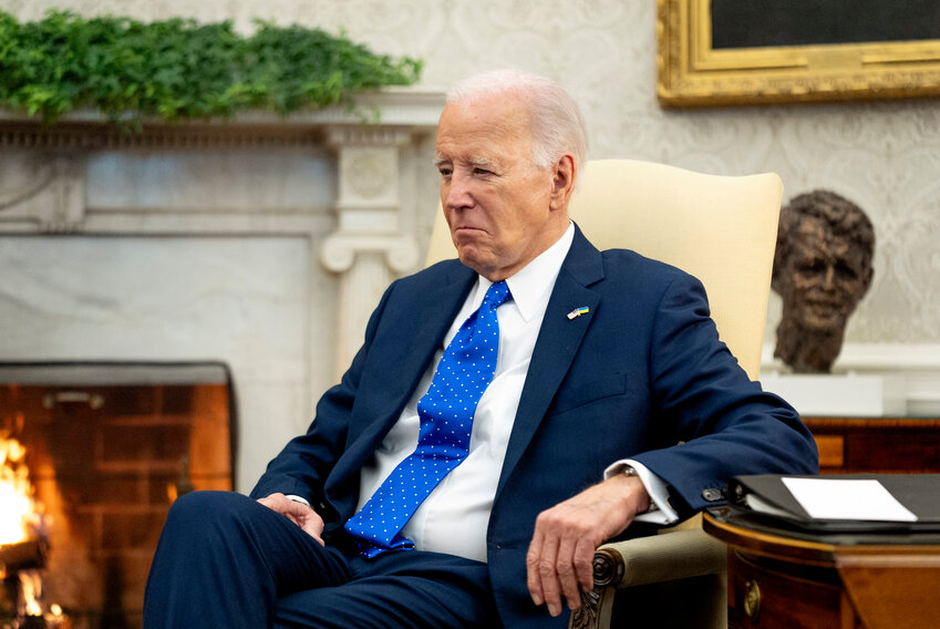 President Joe Biden sits in the Oval Office of the White House, Feb. 9, 2024, in Washington.