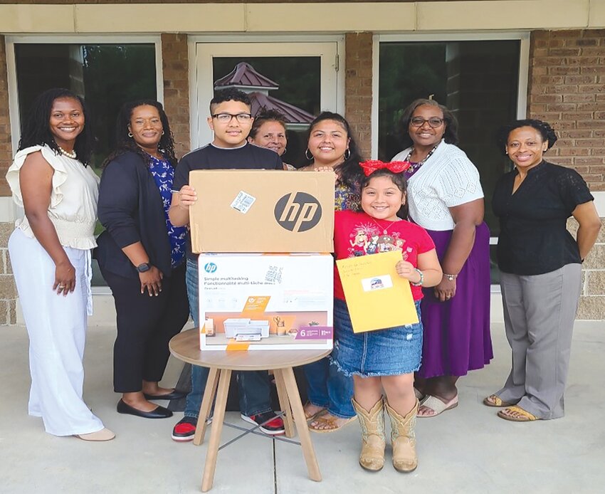 The winners of a home computer and printer stand with PARK and Sumter County Prevention Team members during a previous PARK resource fair.