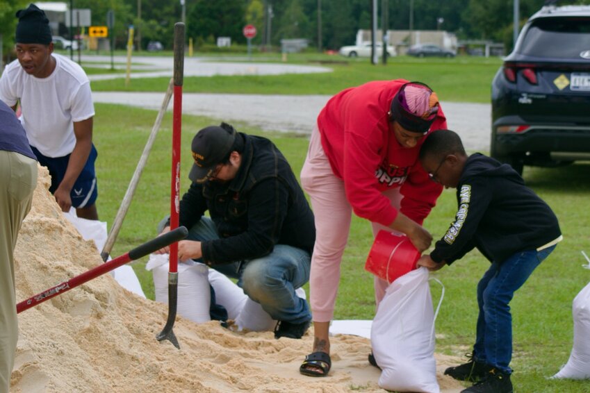 People fill up sandbags at Dillon Park on Monday, Aug. 5.