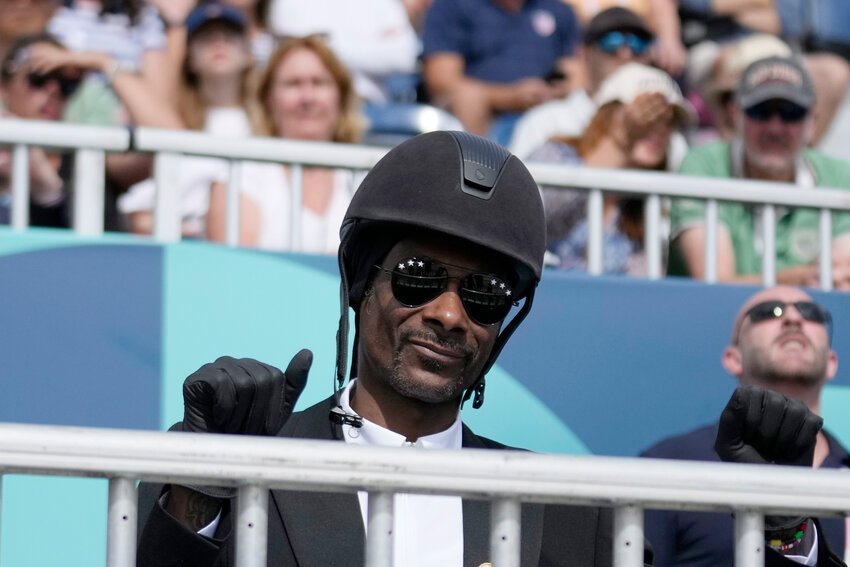 Snoop Dogg thumbs up as he watches the dressage team Grand Prix final at the 2024 Summer Olympics, Saturday, Aug. 3, 2024, in Versailles, France.