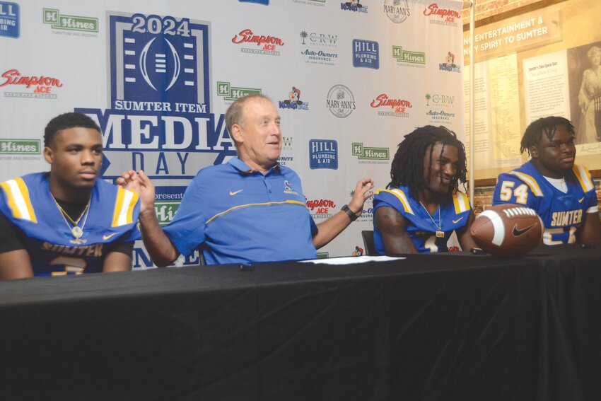 Sumter High head coach Mark Barnes, second from left, sits with John Peeples, left, Kam Fortune, second from right, and Jerius Williams during The Sumter Item&rsquo;s Football Media Day.