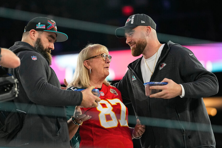 Donna Kelce greets her sons, Philadelphia Eagles center Jason Kelce, left, and Kansas City Chiefs tight end Travis Kelce during the NFL football Super Bowl 57 opening night, Monday, Feb. 6, 2023, in Phoenix.