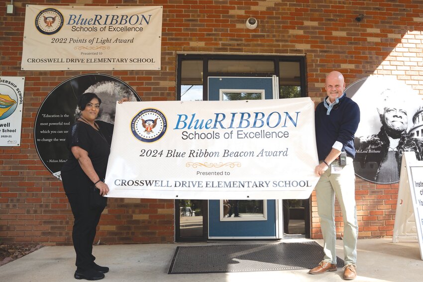 Crosswell Drive Elementary School was recently awarded the Blue Ribbon Beacon Award. Assistant Principal Dr. Tonyetta Thomas and Principal Dr. Shawn Hagerty hold up the banner they received. They'll receive the actual award in December at a ceremony in Orlando, Florida.