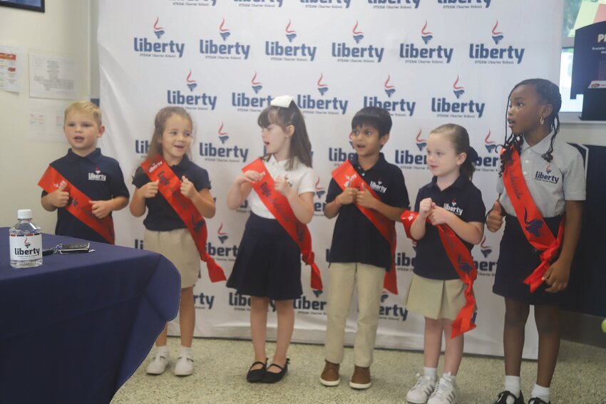 Eagle Ambassadors from Liberty STEAM Charter School's Primary Academy recite the school motto on Monday night at the school's regularly scheduled board of directors' meeting.