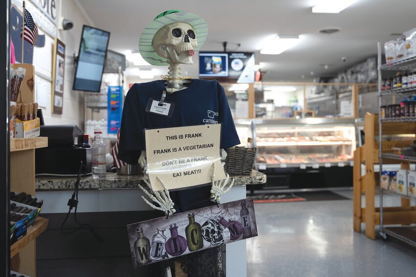 Frank the Skeleton waits for customers inside Carnivore Butcher &amp; Bottle.