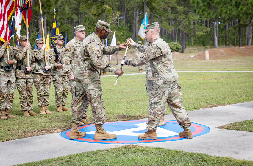 U.S. Army Central &quot;Patton's Own&quot; Lt. Gen. Patrick Frank, USARCENT commanding general, passes the Sword of the Noncommissioned Officer to the incoming Command Sgt. Maj. Eric R. McCray at Patton Hall's Lucky Park, Shaw Air Force Base, on Thursday, Oct. 10.