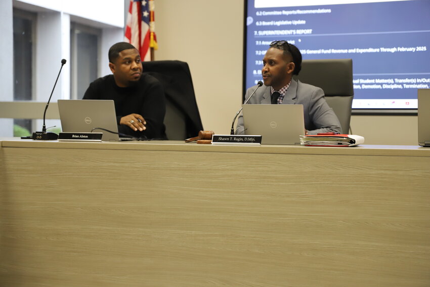 Sumter School District's Board of Trustees Vice Chairman Brian Alston, left, listens as Chairman Shawn Ragin speaks at the full board's last meeting on March 10.