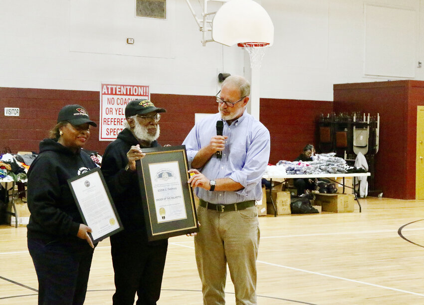 The Rev. Eddie Thomas, center, receives the Order of the Palmetto from former S.C. House District 50 Rep. Will Wheeler in honor of his community service. Thomas founded Good Samaritans for All People, a nonprofit that gives away free goods to those in need, with his wife, Corine Thomas, left.