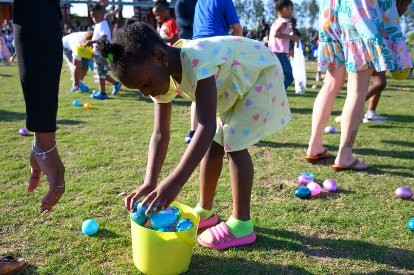 Children pick up Easter eggs at Patriot Park during the Easter egg hunt on Monday, April 14, 2025. Sumter County Recreation and Parks hosted the event. 