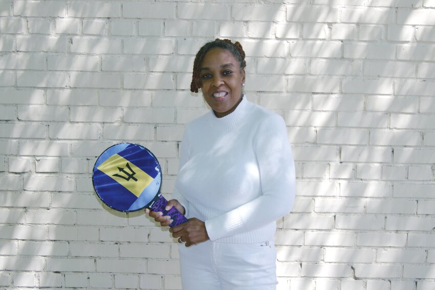 Lakewood High School math teacher Sandrena Carter, who is also the school's teacher of the year for next school year, holds a road tennis racket. She helped bring a cultural project involving the sport to Lakewood recently.