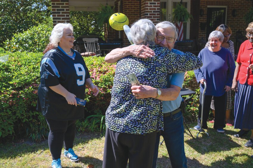 Billy Sams, right, hugs Rebecca Lynn Kennedy, city councilwoman for Ward 4, at Sams' home on Wednesday, April 16, in Sumter. Sams was awarded $500 for his work picking up trash every day in his neighborhood.