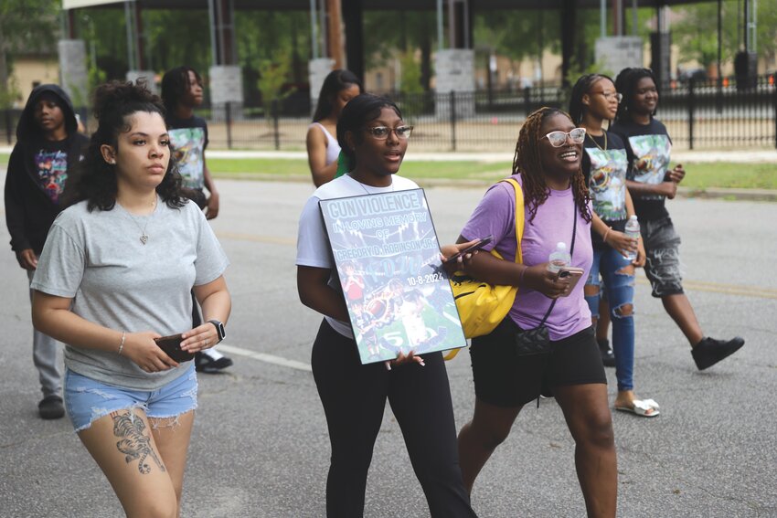 Family, friends and community members walk along Atlantic Avenue for the inaugural event to launch &quot;Forever Doodle World,&quot; a grassroots organization founded in memory of Gregory &quot;Doodle&quot; Robinson in October 2024 after he died because of gun violence at 9 years old.