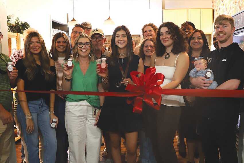 Torrie Champman, 19, is all smiles surrounded by friends, family and Greater Sumter Chamber of Commerce board members at the grand opening of The Juice Box, 13 N. Main St., on Monday, May 5.