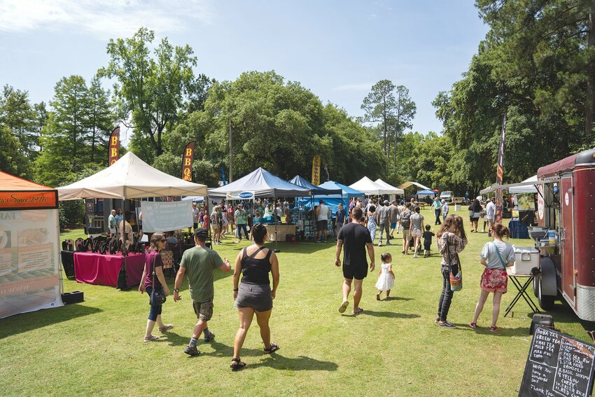 Guests enjoy the Iris Festival in 2024. This year's festival begins Thursday at 6 p.m. with Taste at the Gardens, which includes the crowning of the Iris Festival king and queen, dancing, food and drinks.