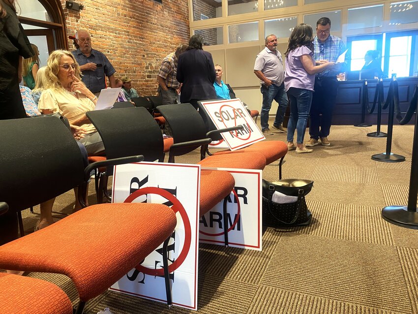 Attendees of a Sumter Board of Zoning Appeals meeting brought signs to protest a solar farm project that was on the agenda. The request was denied, to the joy of residents.