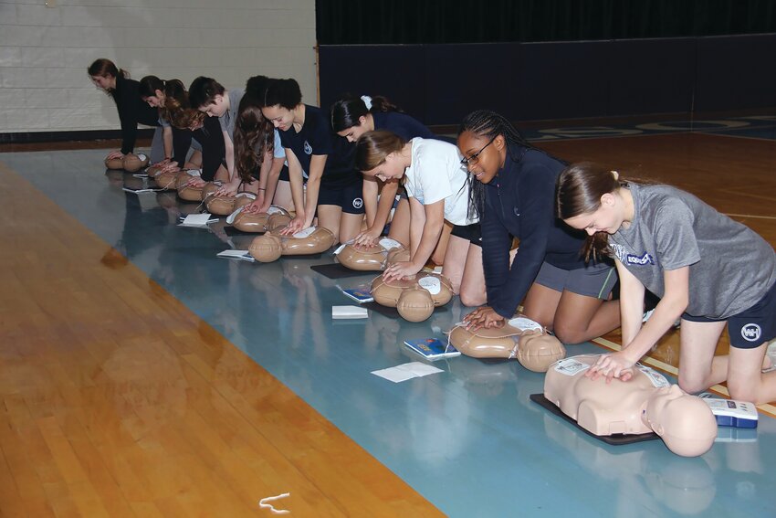 Allyson Sanders, Wilson Hall's registered nurse, provides CPR training to seventh- and eighth-graders during their physical education classes. In December 2023, Wilson Hall received a donation of CPR kits from Mary and Craig Simmons, owners of C. Simmons Construction in Sumter. The couple donated 10 CPR kits to Wilson Hall.
