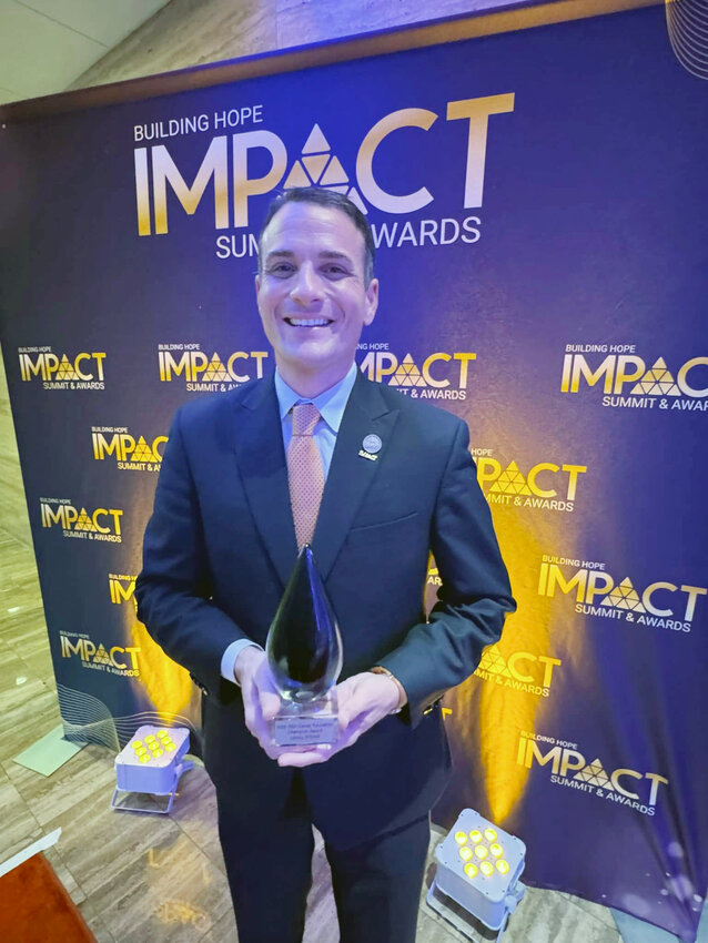 Liberty STEAM Charter School Executive Director Trevor Ivey receives one of two national American Student Assistance Career Education Champion Awards for charter schools at the Building Hope IMPACT Awards ceremony in Miami, Florida, on May 7. A total of 14 charter schools across 11 states won various awards at the national event.