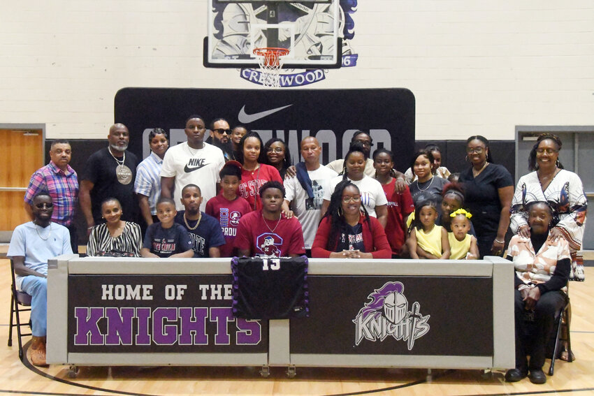 Crestwood's Teon Tindal, center, is surrounded by family after signing with South Carolina State on Thursday.