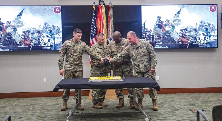U.S. Army Central soldiers cut the Army birthday cake with a Patton Saber to kick off the 250th birthday celebration. From left are the youngest soldier present, Pfc. Jacob Herrera; the ARCENT Chief of Staff Col. Sidney Knox; the ARCENT senior enlisted advisor, Sgt. Maj. Eric McCray; and the oldest soldier, Lt. Col. William Doolan. Having the youngest and oldest soldier help cut the cake symbolizes the past and future of our Army.
