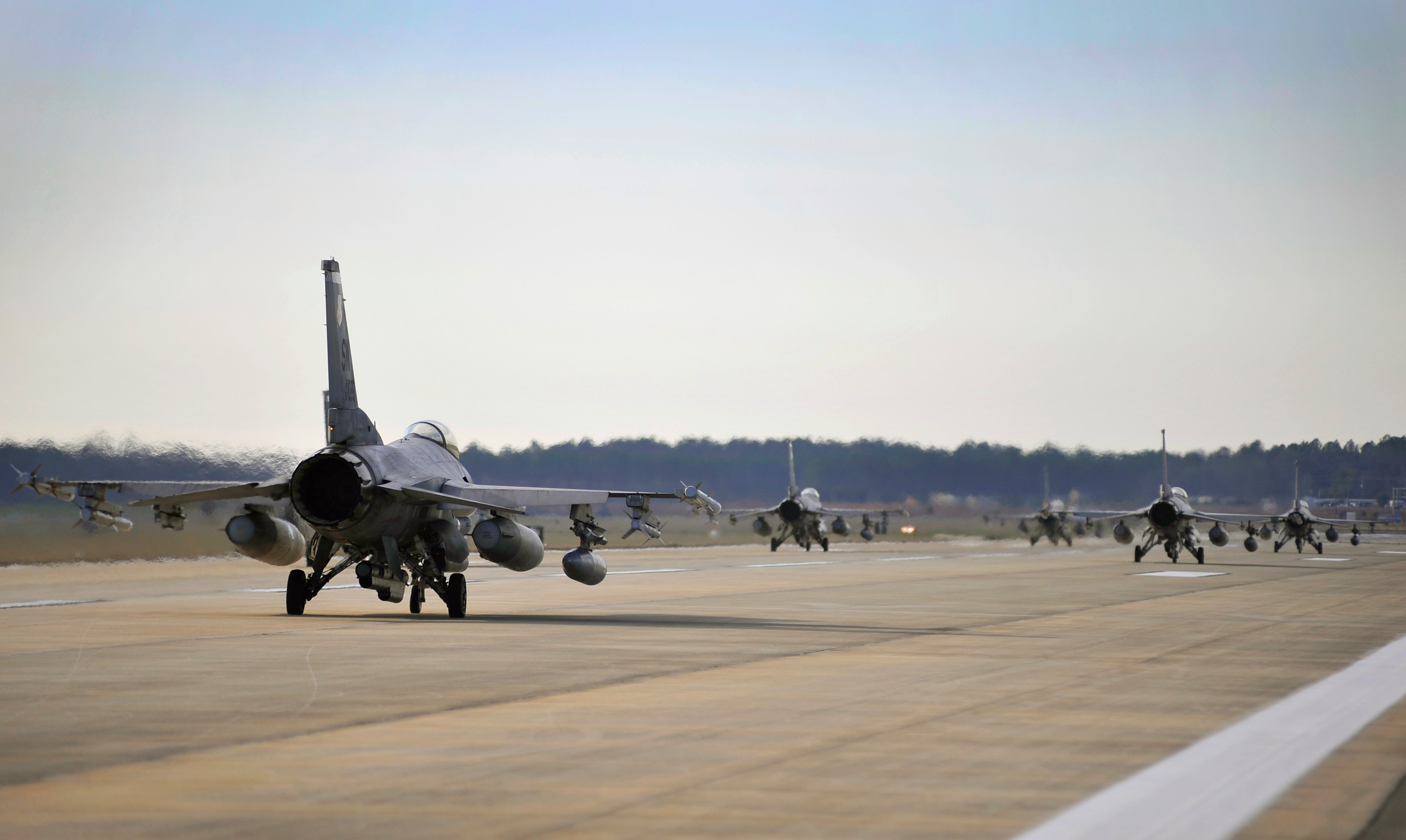 Several U.S. Air Force F-16 Fighting Falcons taxi down the Shaw runway after being prepped and launched during an Operational Readiness Exercise, Jan. 31, 2012, Shaw Air Force Base.