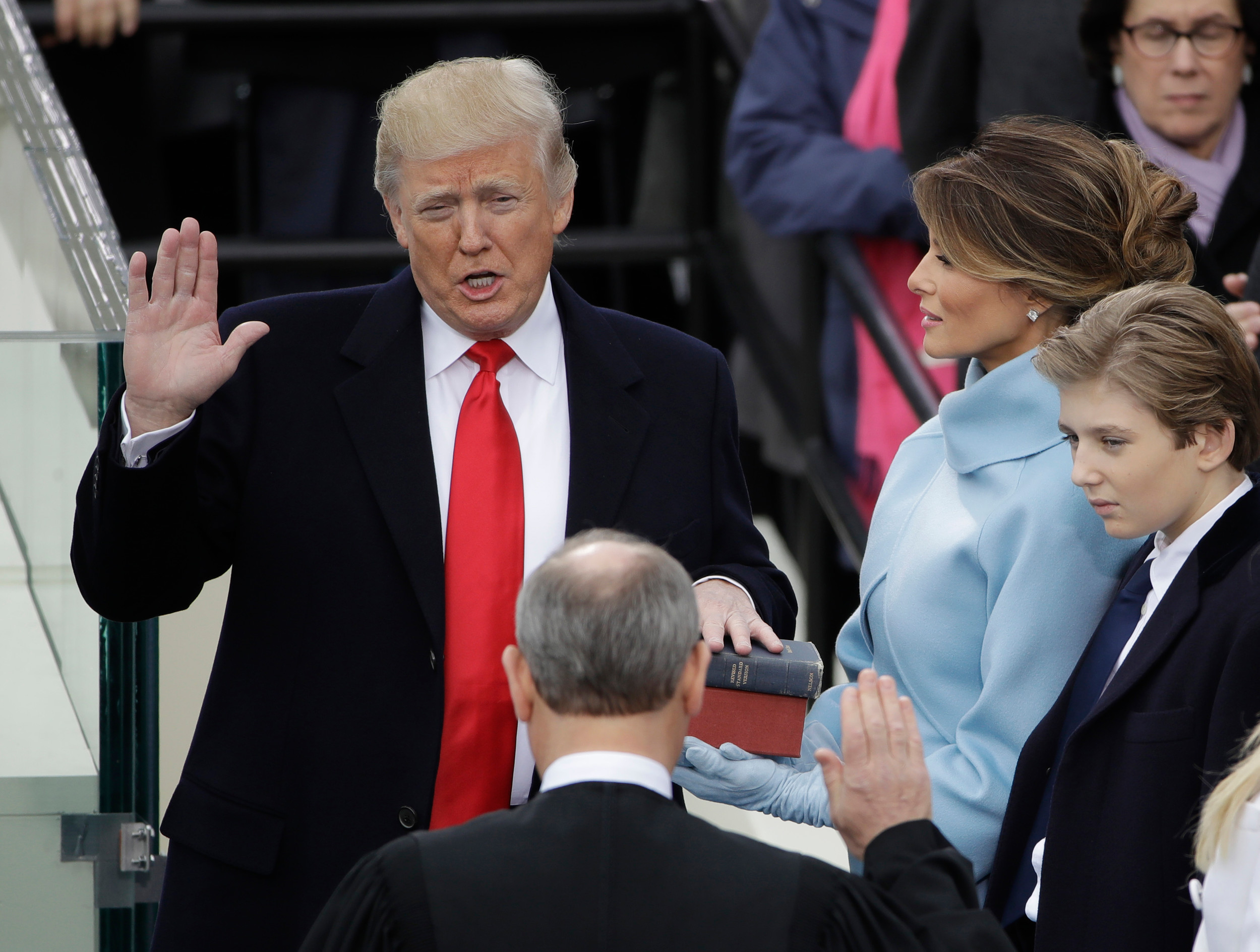 Donald Trump is sworn in as the 45th president of the United States by Chief Justice John Roberts as Melania Trump looks on during the 58th Presidential Inauguration at the U.S. Capitol in Washington on Jan. 20, 2017. Trump's inaugural committee spent more than $1 million to book a ballroom at the Trump International Hotel in the nation's capital as part of a scheme to "grossly overpay" for party space and enrich the president's own family in the process, according to a lawsuit filed Wednesday.