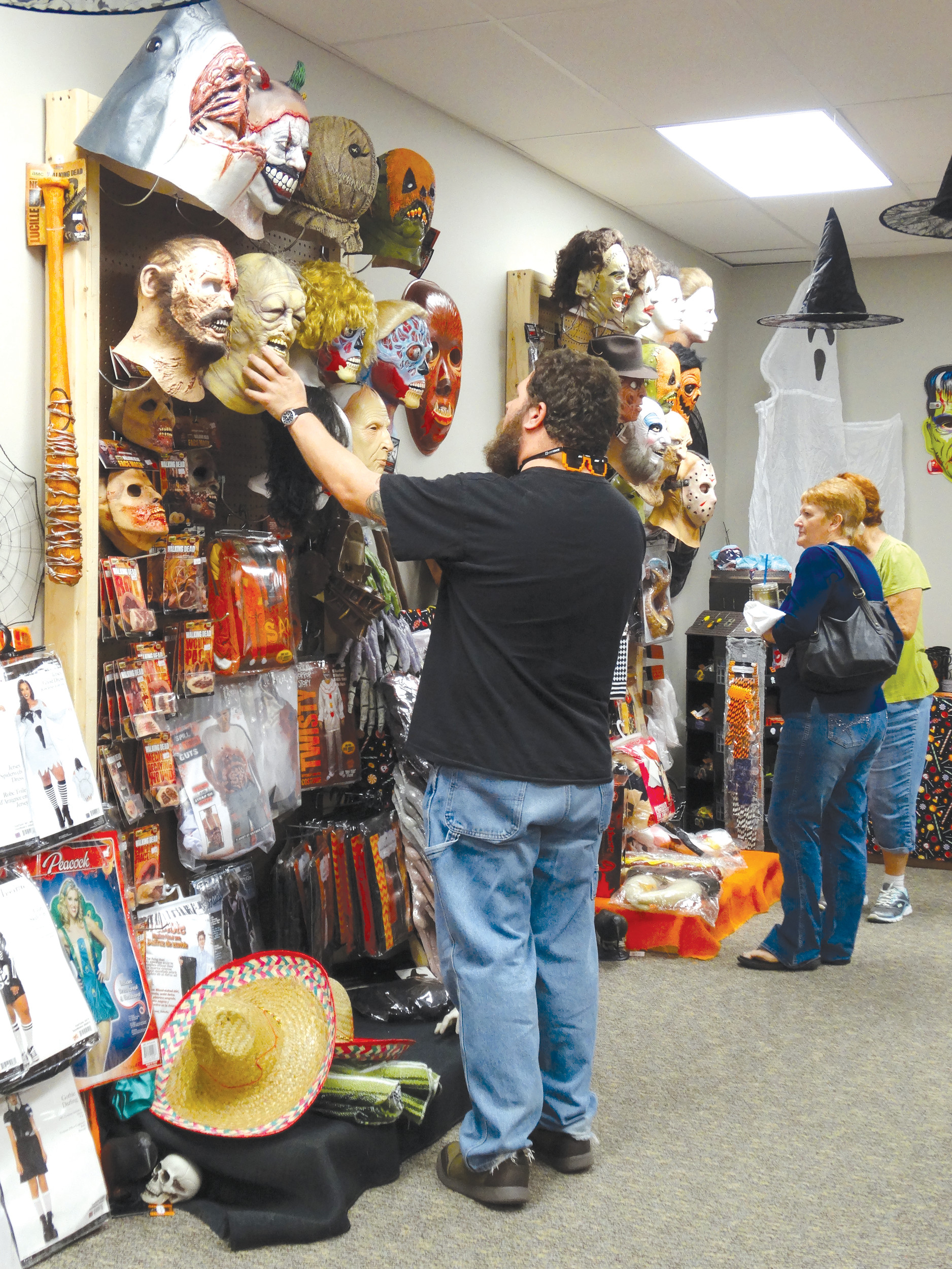 Jeff Whisnant of Sumter checks out a mask at M and M's Lil Shop o' Horrors on West Liberty Street on Tuesday afternoon. He said he'd heard about the Halloween shop on Facebook and that his friends were also interested in visiting the new store. It will be open through the first week of November and offers costumes and fall decorations.