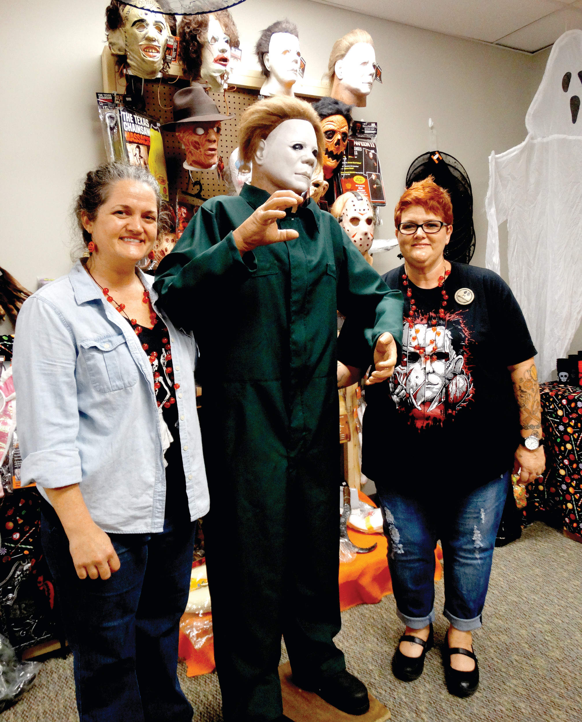 Melanie Lee, left, Michael Myers, center, and Miranda Johns are seen on the day of the grand opening of M and M's Lil Shop O' Horrors on Tuesday. The shop, located on West Liberty Street, sells a variety of Halloween costumes and decorations as well as fall and Thanksgiving items.