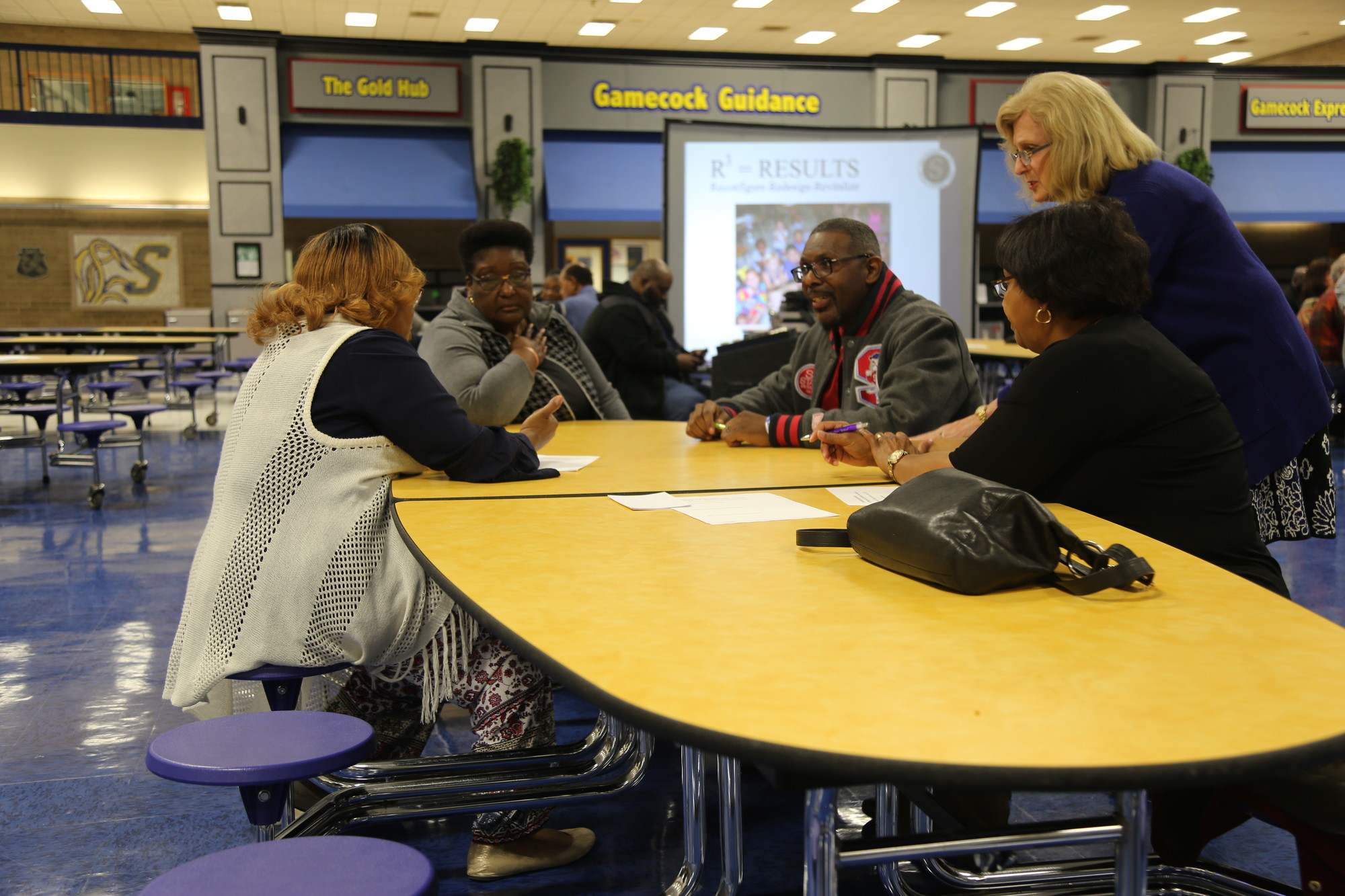 Sumter School Board at-large member Bonnie Disney, standing, listens and participates in a round-table discussion at Thursday's community conversation session at Sumter High School.