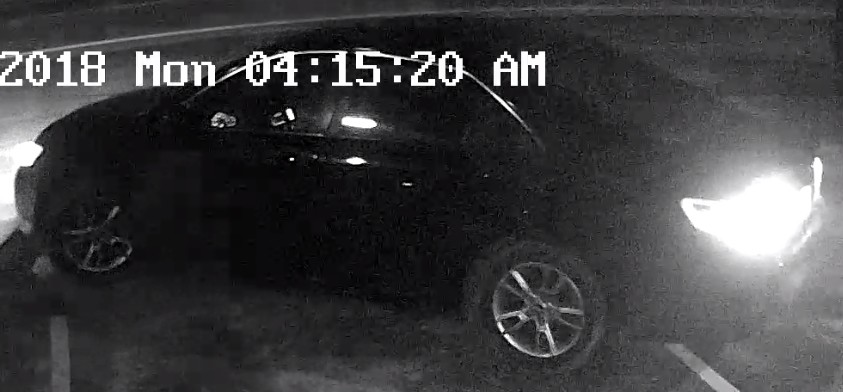 The suspects drove up in this vehicle, which appears to be a late model dark-colored Toyota Camry.