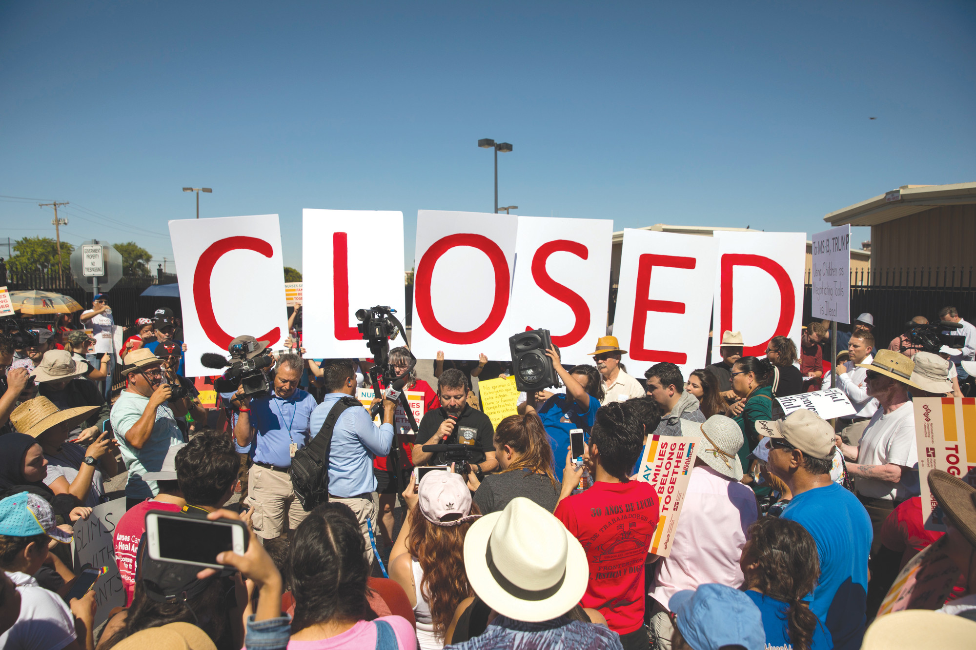Protesters stand outside the U.S. Immigration and Customs Enforcement processing center in El Paso, Texas, on Tuesday. President Donald Trump on Wednesday signed an executive order to stop separation of families crossing the U.S. border. The "zero-tolerance" policy to prosecute adults crossing the border illegally is still in effect.