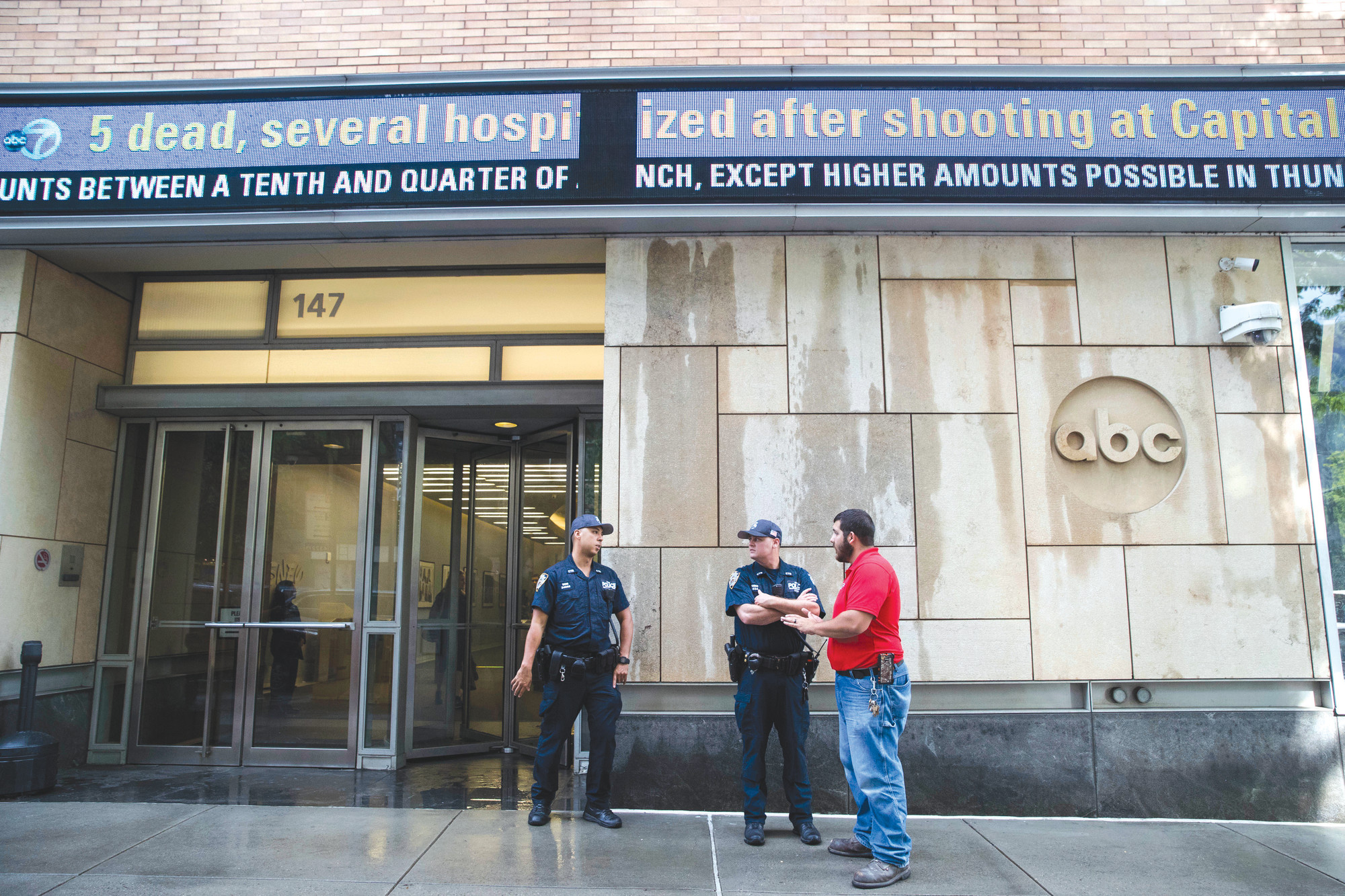 Police officers stand guard outside the ABC studio Thursday in New York.