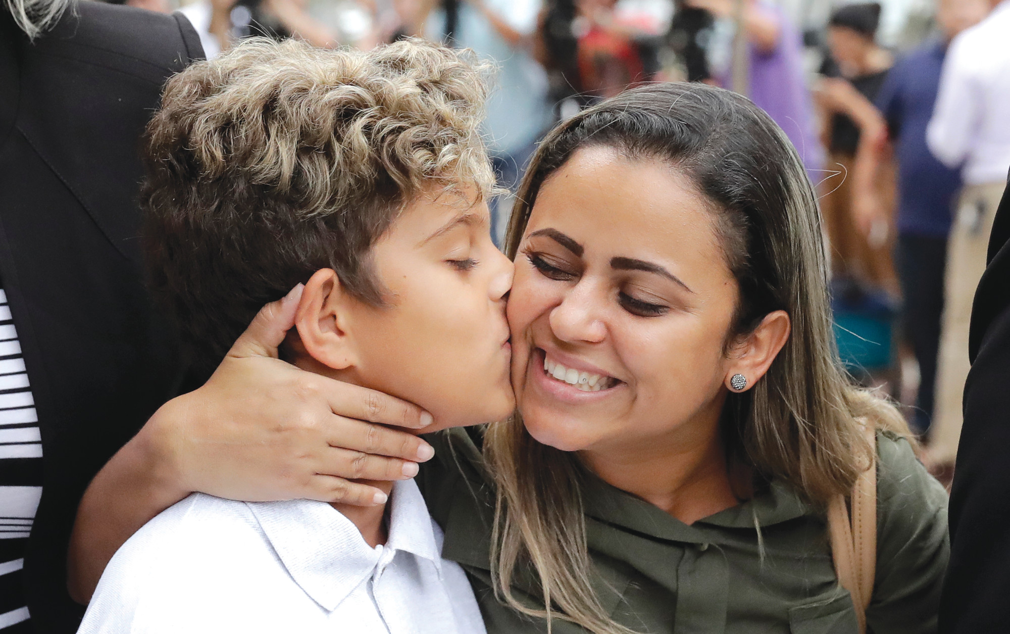 Diego Magalhaes, left, 10, kisses his mother Sirley Silveira Paixao, an immigrant from Brazil seeking asylum with her son, after Diego was released from immigration detention on Thursday in Chicago.