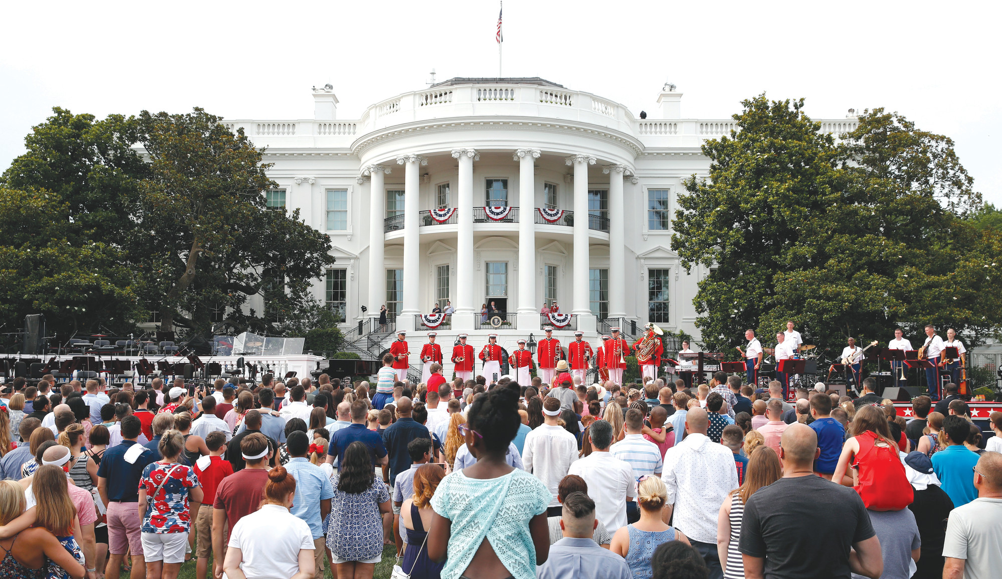 Visitors gather at the White House for the playing of the national anthem during an afternoon picnic for military families on the South Lawn of the White House on July 4 in Washington.