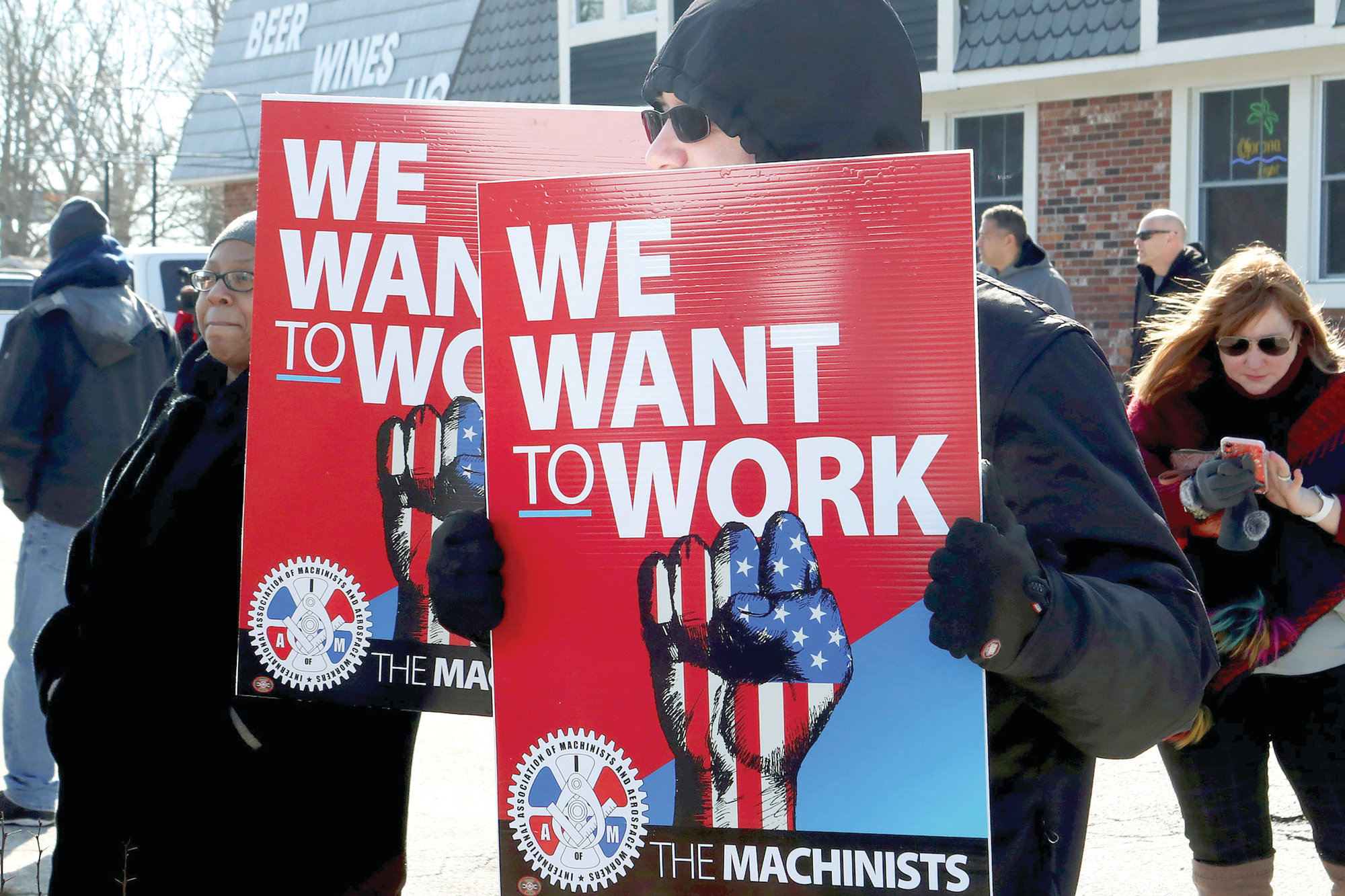 Members of unions, federal workers and contractors hold a rally to end the partial shutdown of the federal government at Airport Circle in Egg Harbor Township, New Jersey, on Friday.