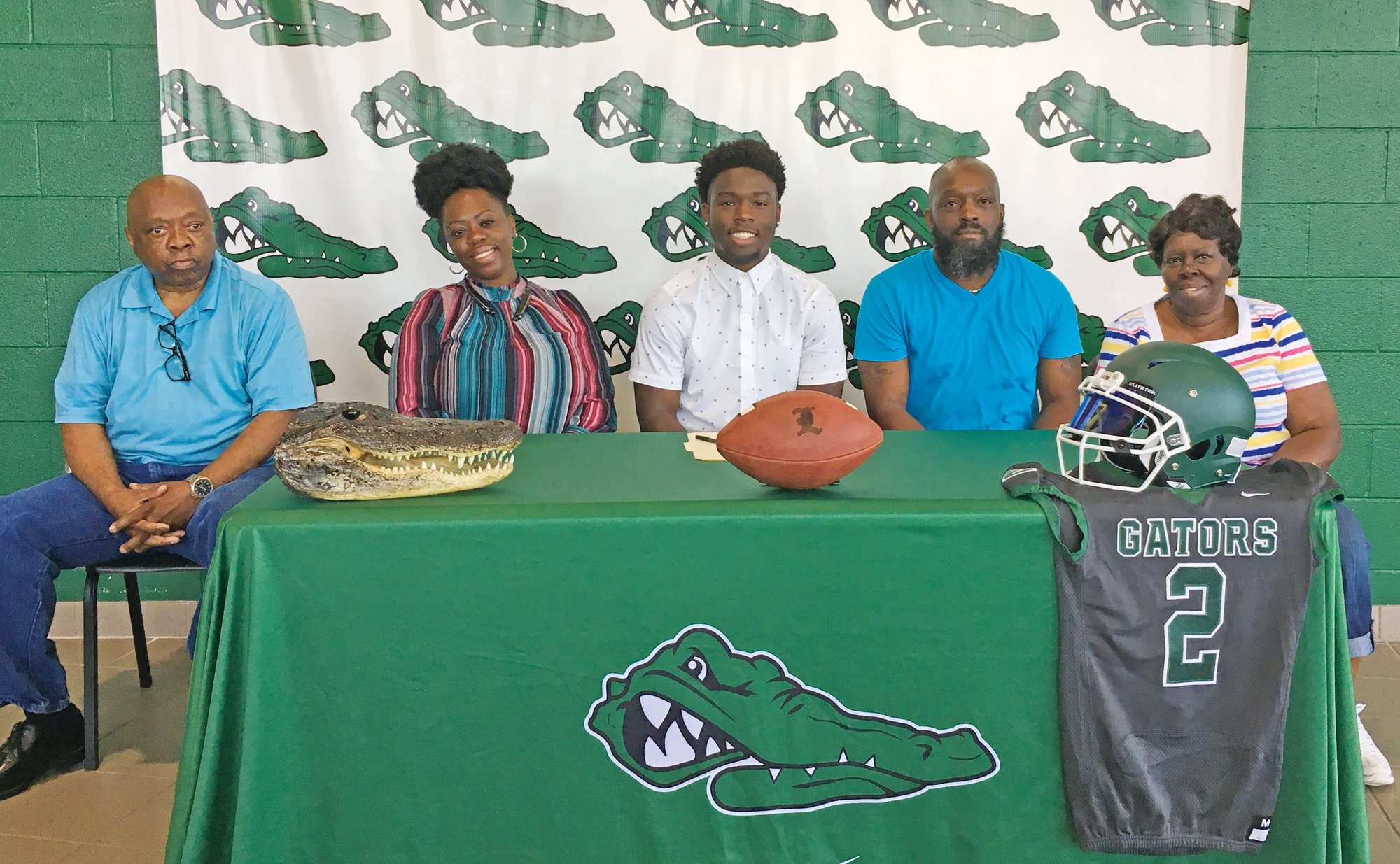 Lakewood High School's Javontae' Jones, seated in the center, has signed to play college football with Greensboro College. Seated with Jones from left to right are grandfather James Scott, mother Cheryl Jones, father Joseph Jones and grandmother Millie Scott,