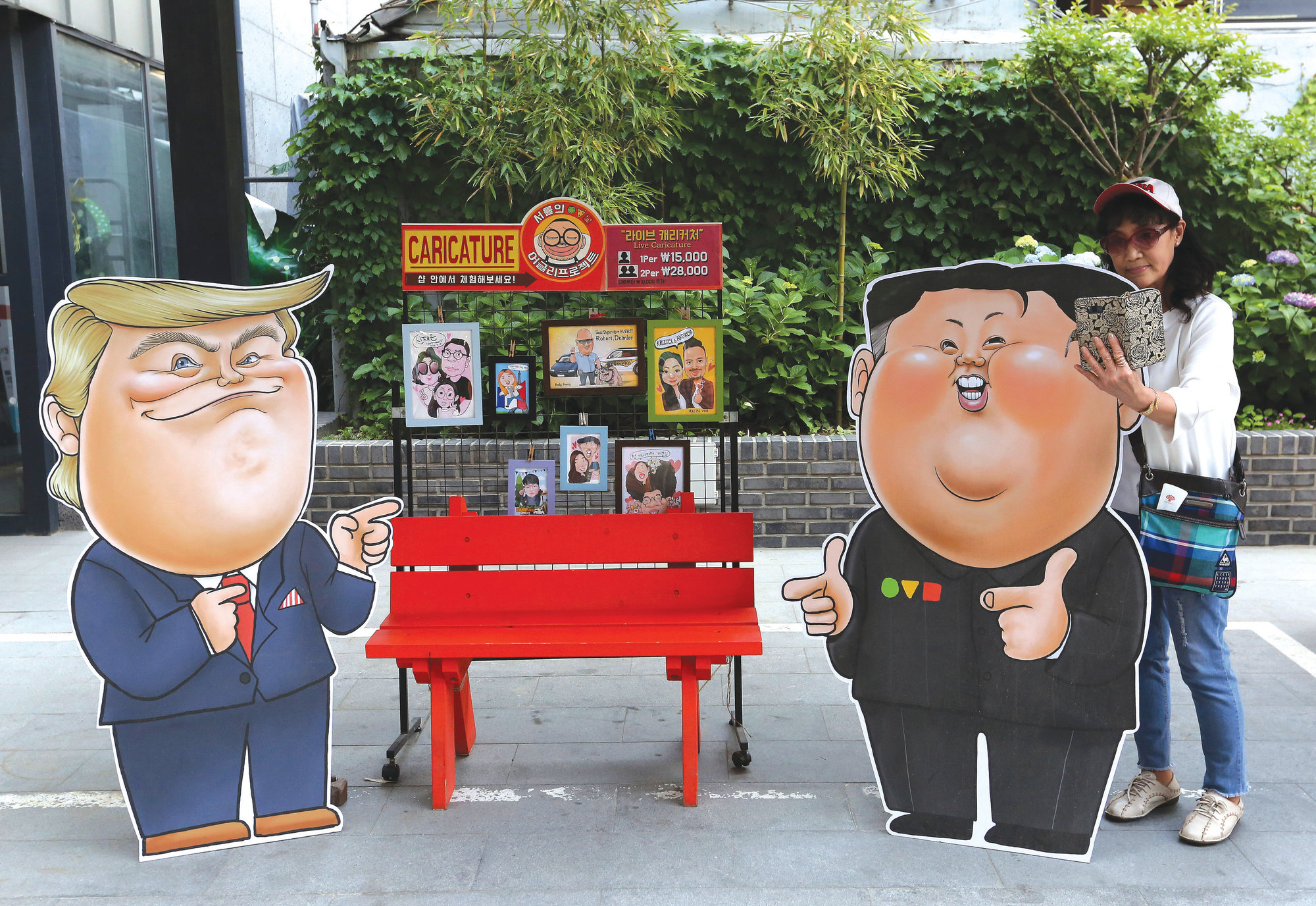Caricatures depicting U.S. President Donald Trump, left, and North Korean leader Kim Jong Un are displayed in Seoul, South Korea, on Sunday. In an apparent contradiction of his national security adviser, President Donald Trump on Sunday downplayed recent North Korean missile tests, tweeting from Tokyo that they're not a concern for him.