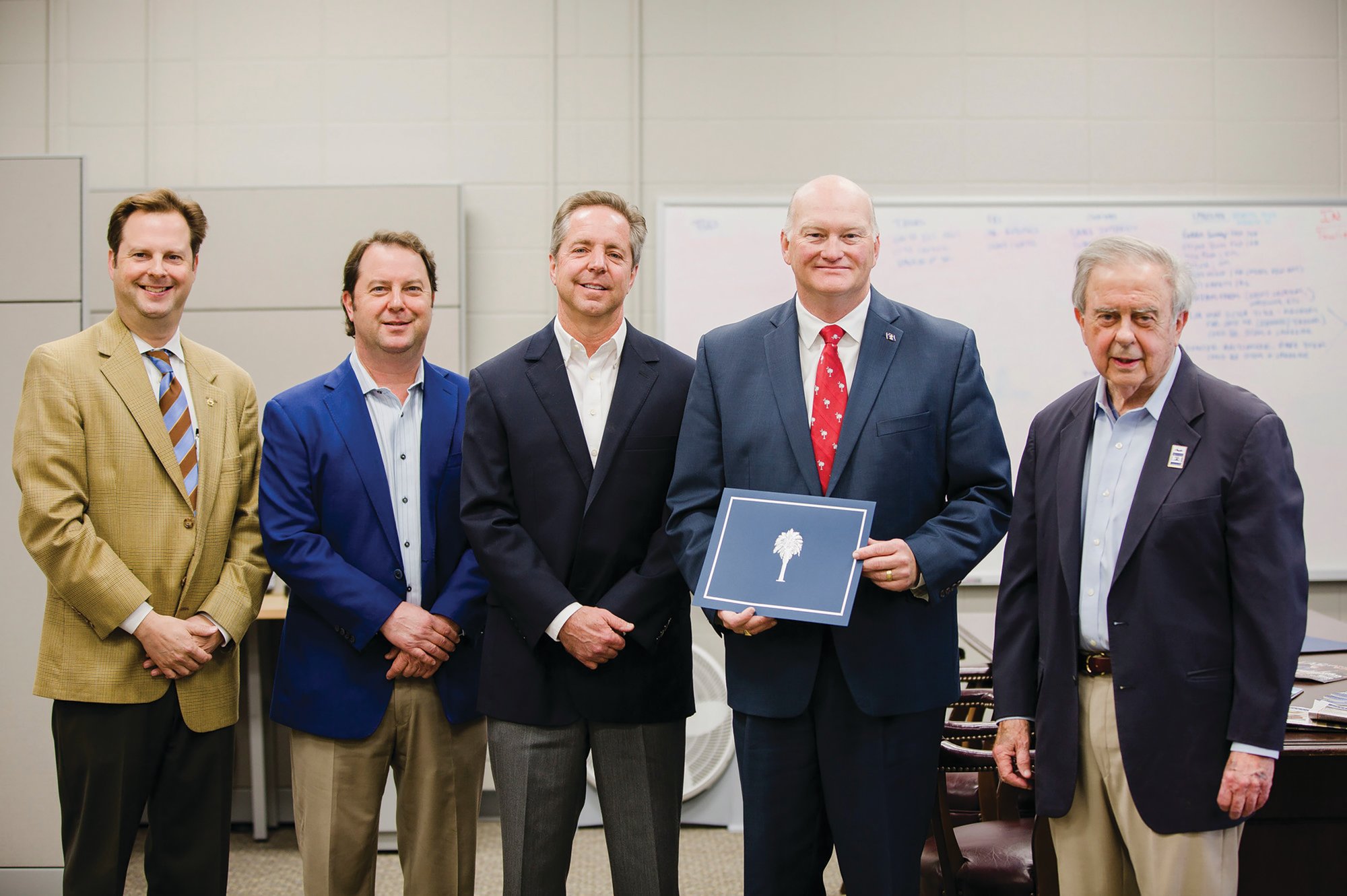 From left, Jack, Kyle and Graham Osteen stand with South Carolina Secretary of State Mark Hammond and their father, Hubert D. Osteen Jr., in The Sumter Item newsroom in March 2018. Hammond recognized the newspaper for being on file with the Secretary of State's Office for more than 100 years. The newspaper celebrated 125 years of serving the Sumter community in October 2019.