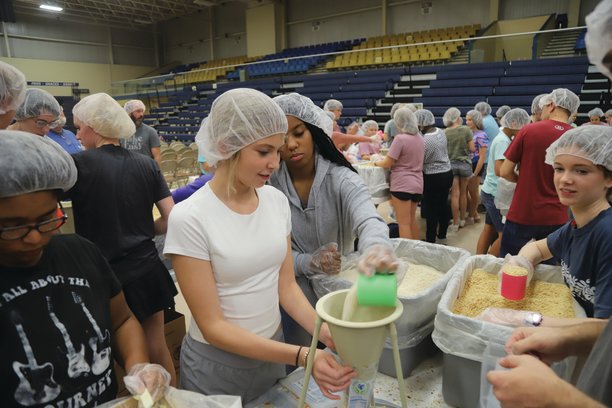 Teenagers Carolina French, left, and Kinsley Billie prepare meals for overseas on Saturday at "One Weekend" at Sumter County Civic Center. A total of 13 churches across Sumter participated in the discipleship weekend that leads into the Tony Evans Sumter Crusade, which is tonight through Thursday at the civic center. Music begins each night at 6:30 p.m. The crusade is a free event with no tickets required, but people are advised to arrive early.