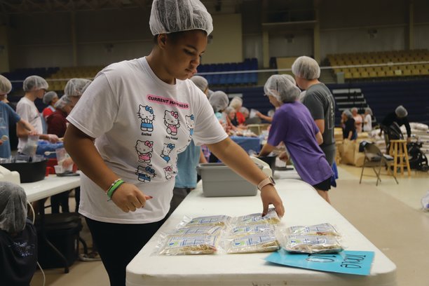 Shaelyn Davenport sets prepared meals for overseas on a table Saturday.