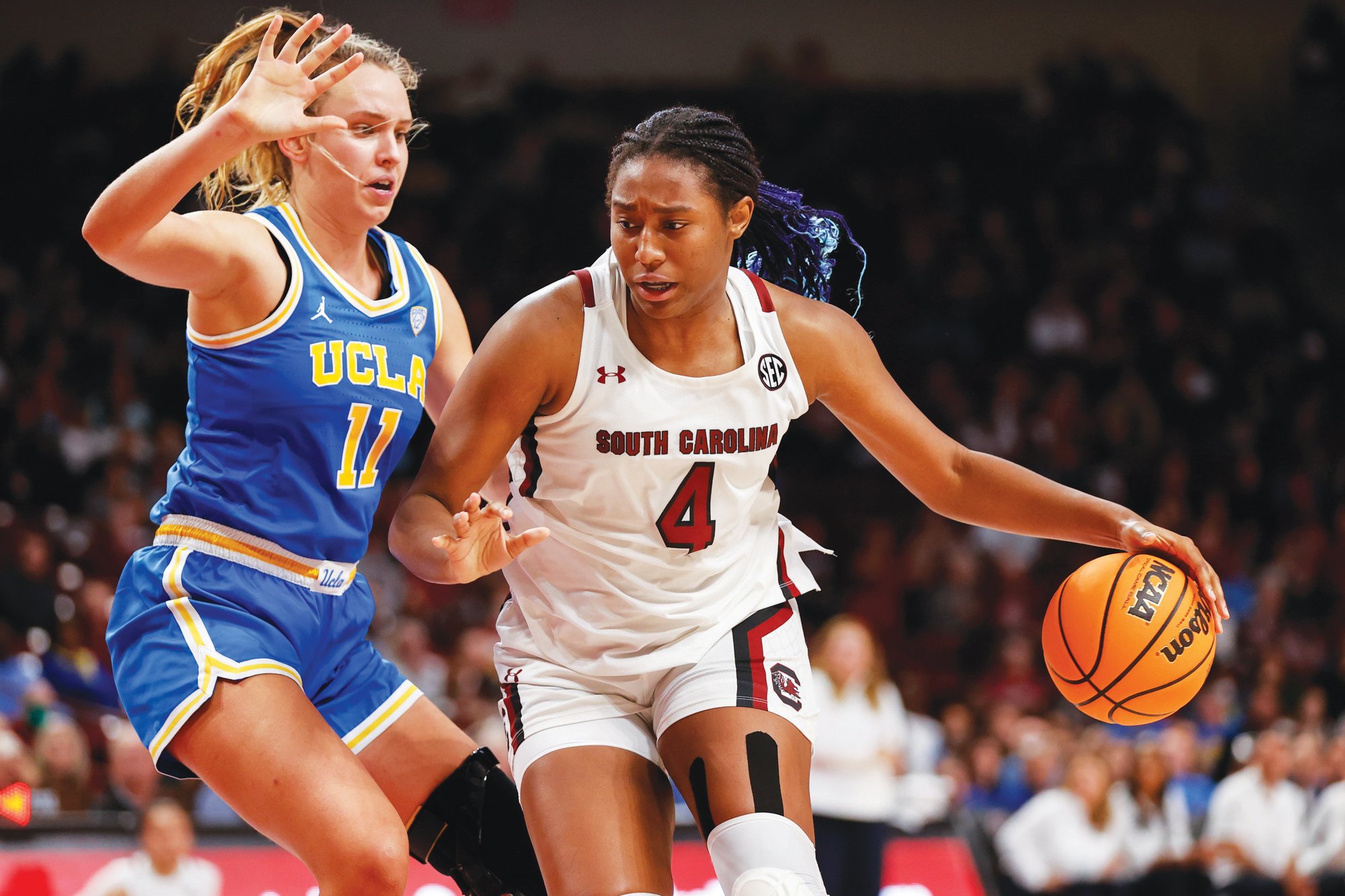 South Carolina forward Aliyah Boston, right, drives against UCLA forward Emily Bessoir the Gamecocks' win in Columbia on Tuesday.
